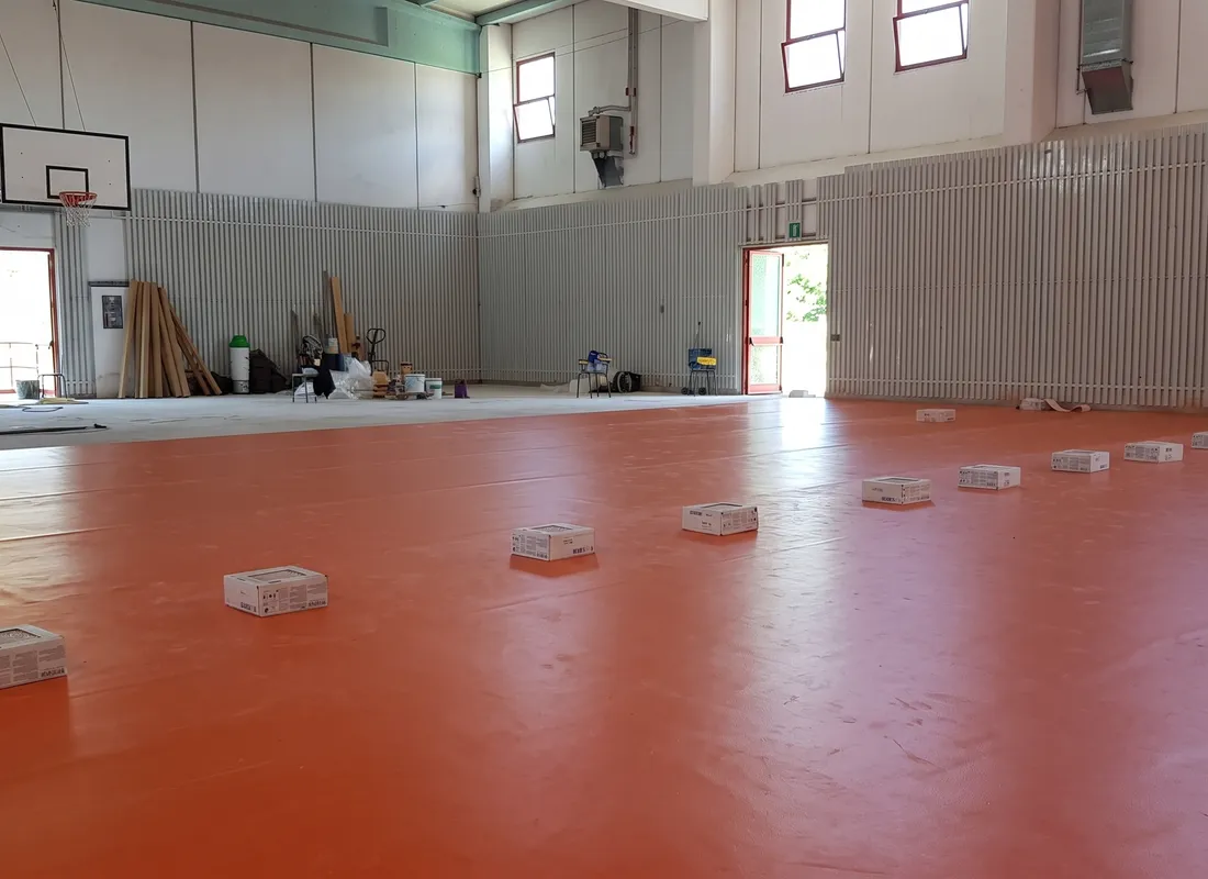 Vinyl flooring being laid in the gym