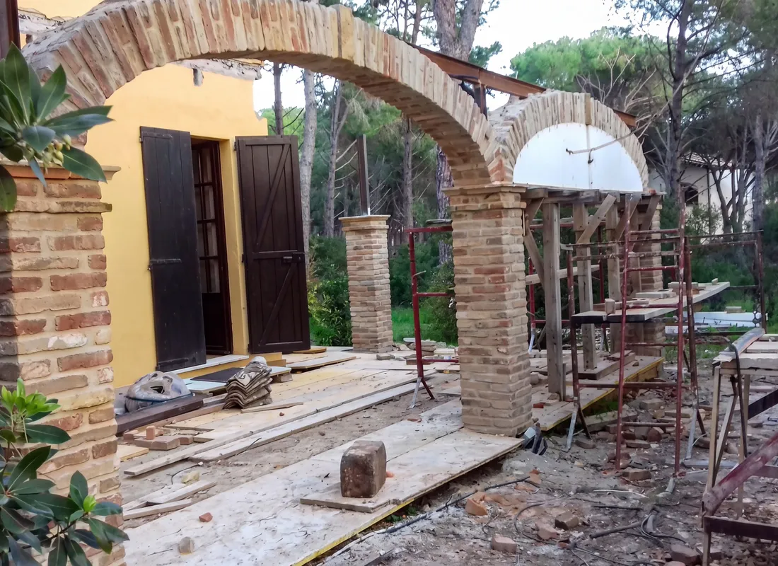 The veranda under construction: brick arches and pillars being built