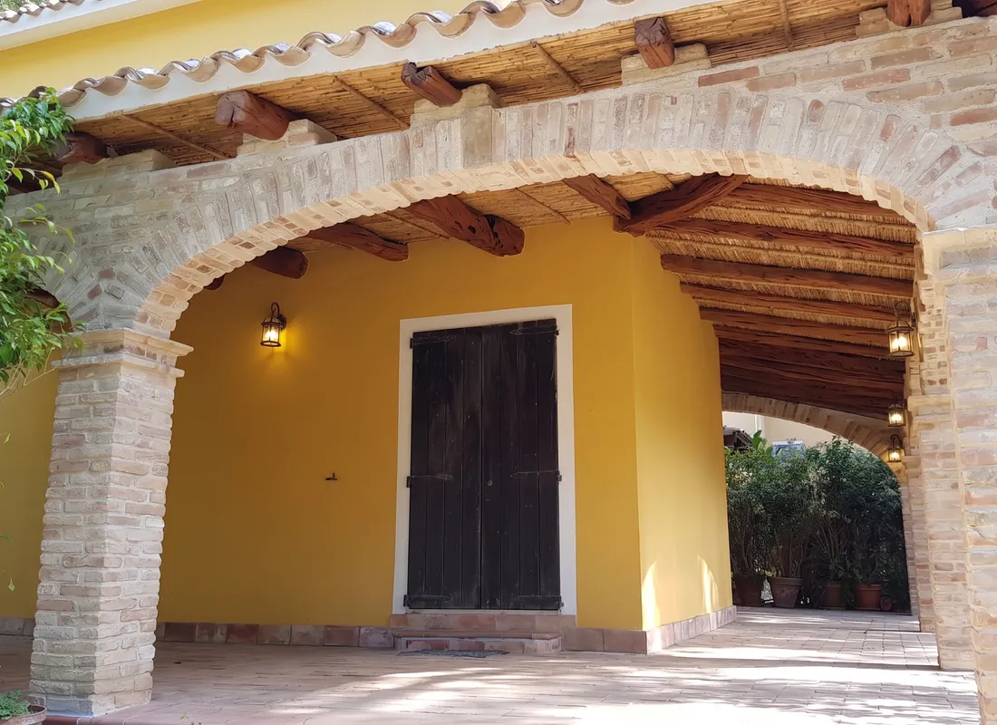 Daytime detail of the brick arch and the timber roof