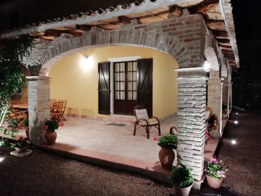 Facciata della villa con veranda illuminata al tramonto