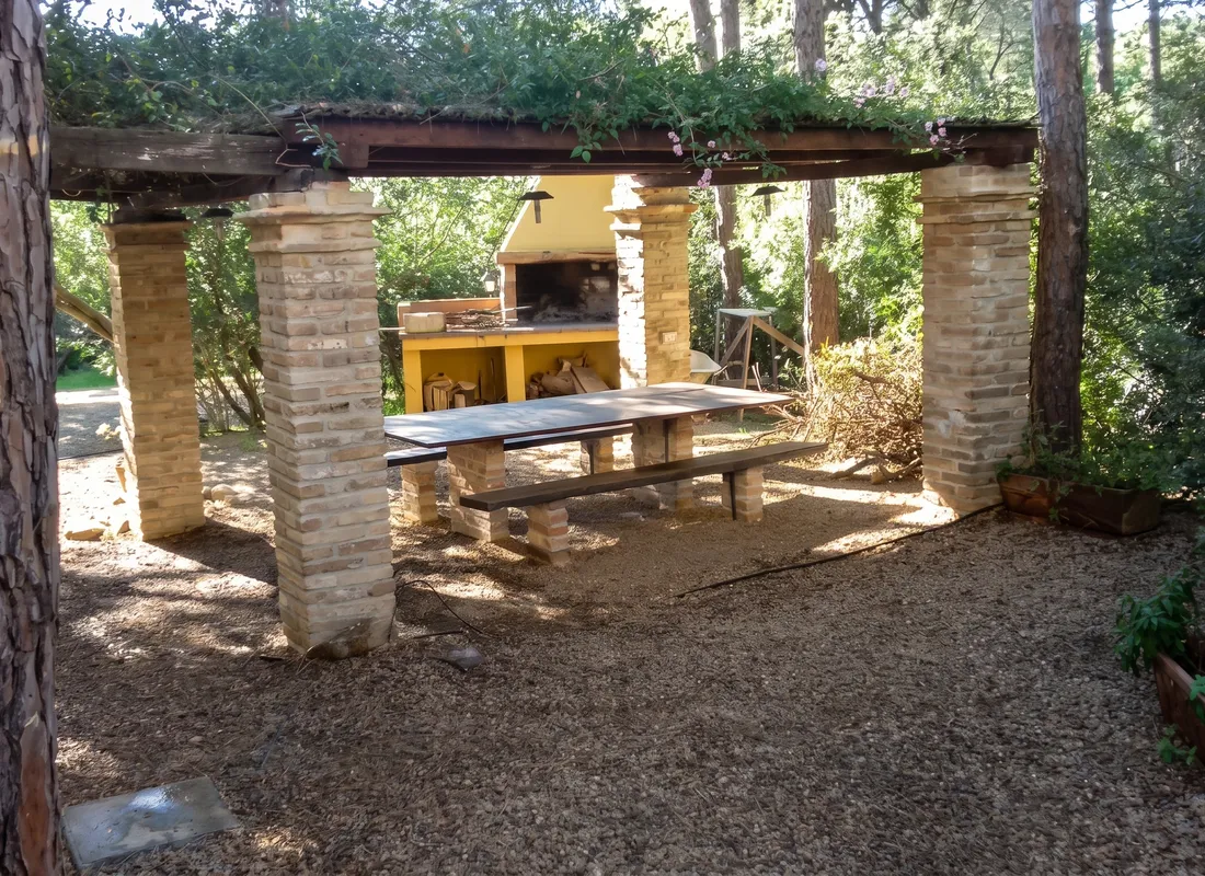 The finished gazebo with dining table and brick barbecue